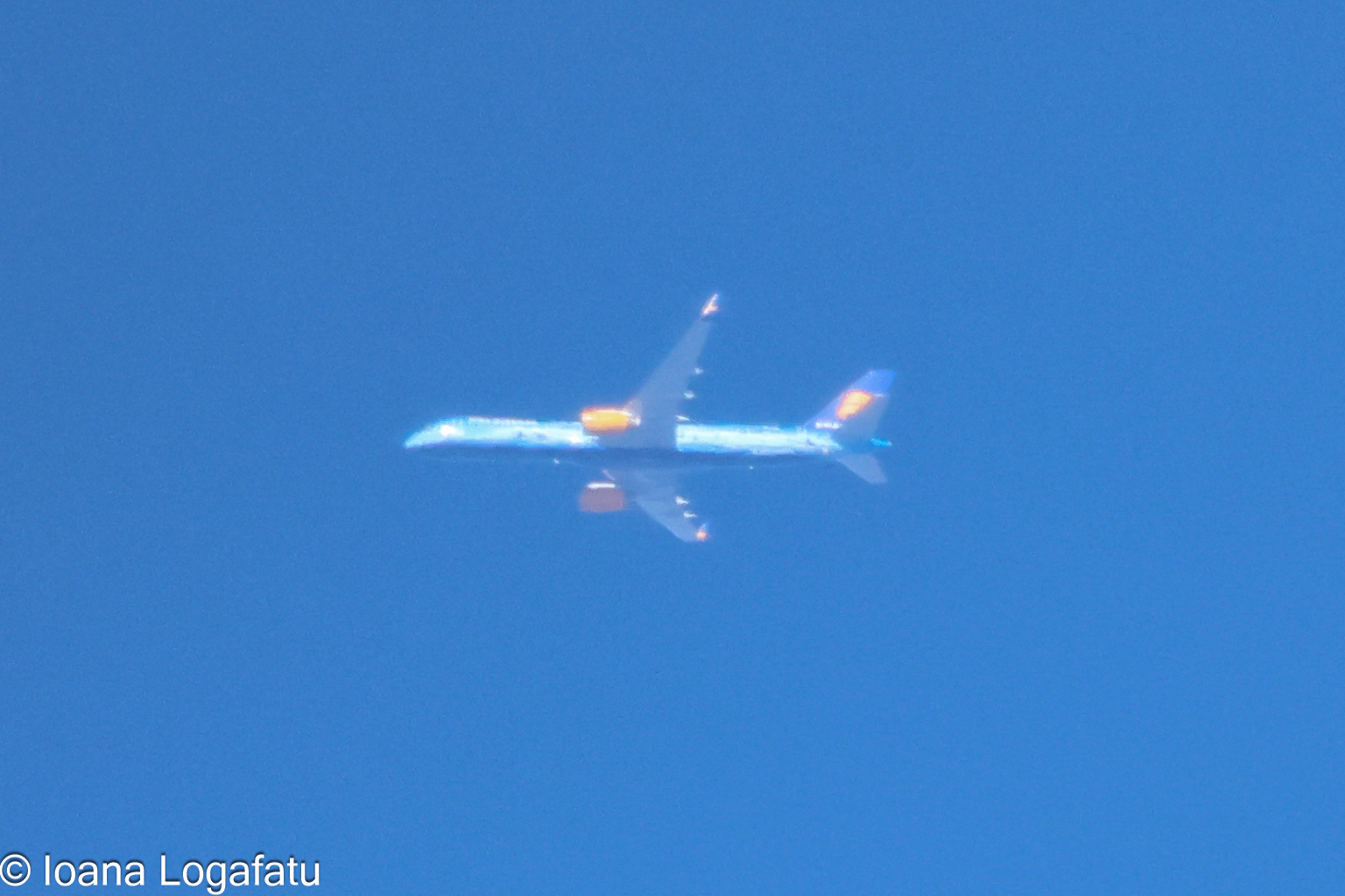 A plane soars high above the city